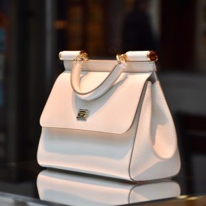 a white purse sitting on top of a table